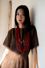 Load image into Gallery viewer, Goulu statement beaded necklace in beads and brass bell
